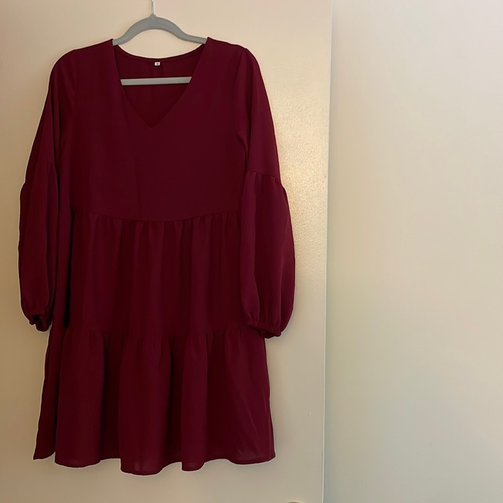 Long-sleeve, tiered-skirt dress in maroon.